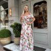 Romantic off-shoulder floral maxi dress with double ruffle neckline, elastic neckline and cinched elastic waist displayed on a white background