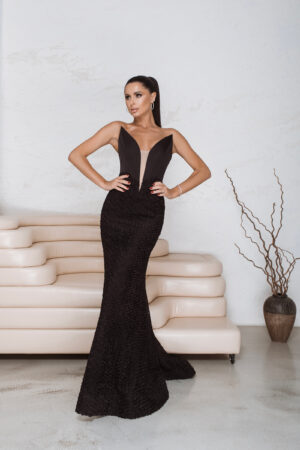 Drop waist black gown with sculpting corset and textured rose-appliqué skirt for formal occasions