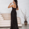 bespoke black gown with train and elegant thigh-high slit.