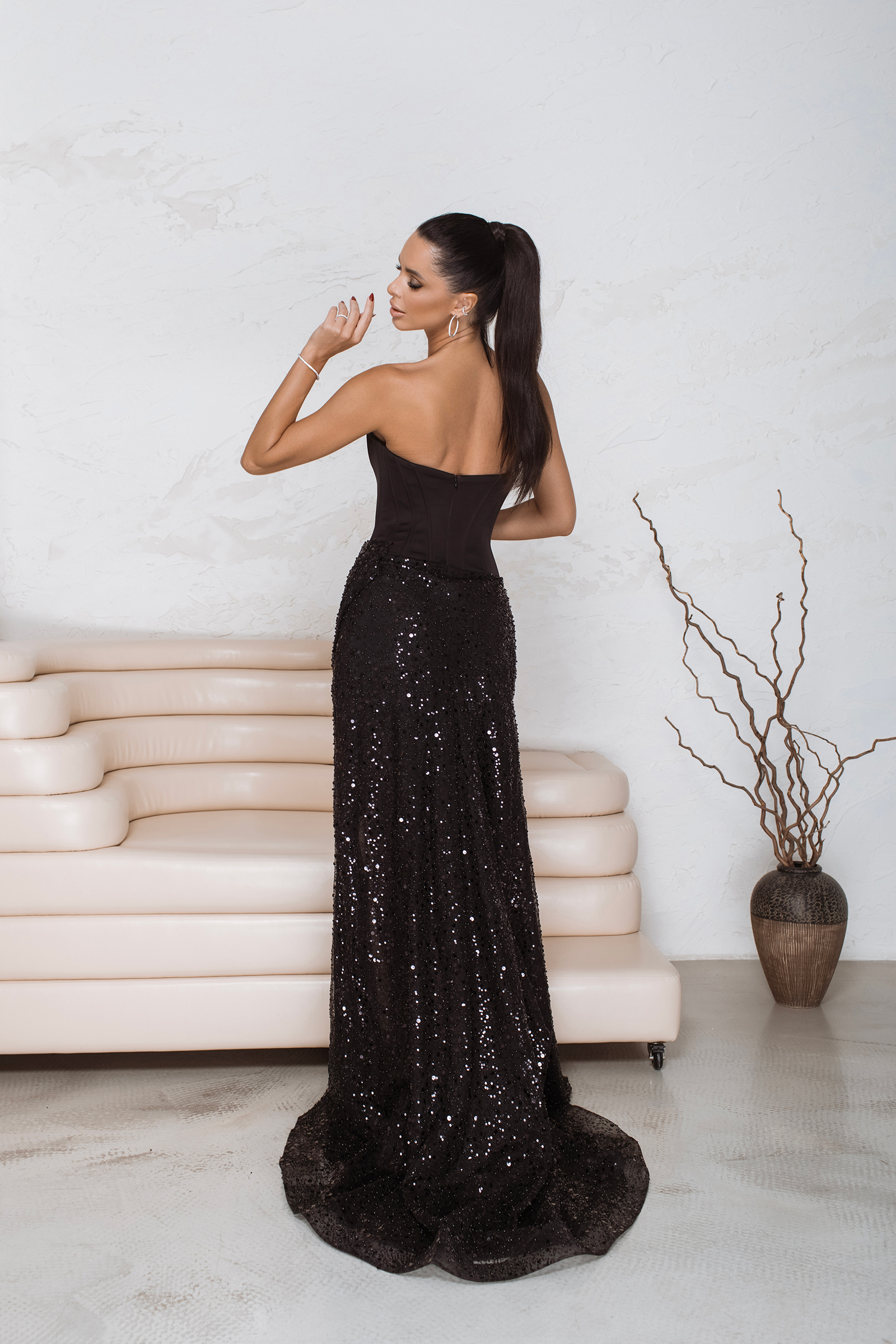 bespoke black gown with train and elegant thigh-high slit.