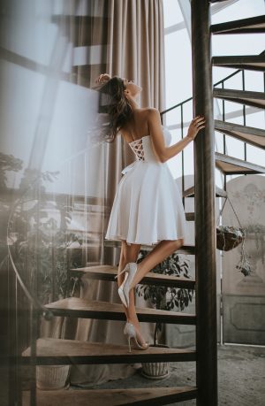 Handmade ivory wedding dress with off-shoulder design and lace-up back