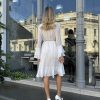 Back view of white ruffle midi dress with asymmetrical hem - cottagecore wedding dress